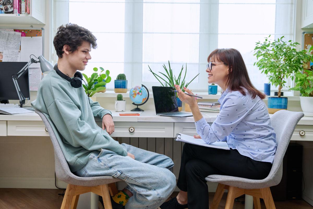 Two people sitting across from each other having a conversation.